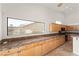 Bright kitchen showcases granite counters, light wood cabinets, and ample natural light through a large window at 517 Chance Cove Dr, Henderson, NV 89052