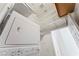 Well-lit laundry room featuring a stacked washer/dryer unit with ample shelving at 517 Chance Cove Dr, Henderson, NV 89052