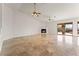 Spacious living room featuring tile floors, a modern fireplace and sliding door to patio at 517 Chance Cove Dr, Henderson, NV 89052