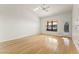 Bright living room with beautiful wood floors, large window, and direct patio access at 517 Chance Cove Dr, Henderson, NV 89052