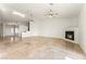 Bright living room with fireplace, tile floors, and access to front door and staircase at 517 Chance Cove Dr, Henderson, NV 89052