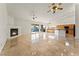 Open-concept layout of living room, kitchen with tile floors and sliding glass doors at 517 Chance Cove Dr, Henderson, NV 89052