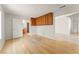 Open living room with hardwood floors, white walls, view to bathroom, and cabinets at 517 Chance Cove Dr, Henderson, NV 89052