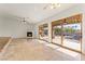 Open-concept living area with fireplace, tile floors and access to outdoor patio at 517 Chance Cove Dr, Henderson, NV 89052