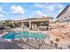 Refreshing backyard pool with a rock waterfall feature and a covered patio at 517 Chance Cove Dr, Henderson, NV 89052