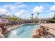 Landscaped backyard with a sparkling pool, rock waterfall, and lounge area at 517 Chance Cove Dr, Henderson, NV 89052