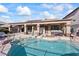 Stunning backyard featuring a pristine pool, covered patio, and lush greenery at 517 Chance Cove Dr, Henderson, NV 89052