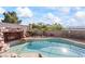 Well-maintained pool area with rock features, seating, and mature landscaping at 517 Chance Cove Dr, Henderson, NV 89052