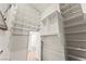 Walk-in closet with adjustable shelving, hanging rods, and access door to another room at 517 Chance Cove Dr, Henderson, NV 89052
