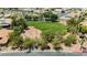 Aerial view of landscaped green common area with desert landscaping and neighboring houses at 6100 Cocktail Dr, Las Vegas, NV 89130