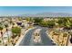 Gated community entrance showcasing lush landscaping, palm trees, and mountain views in a desirable neighborhood at 6100 Cocktail Dr, Las Vegas, NV 89130