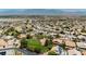 Expansive aerial view of a well-maintained community featuring a mix of single-Gathering homes and green spaces at 6100 Cocktail Dr, Las Vegas, NV 89130