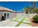 Enchanting backyard featuring concrete pavers, lush artificial turf, and a seamless connection to the indoors through French doors at 6100 Cocktail Dr, Las Vegas, NV 89130