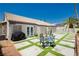 Private backyard featuring artificial turf grass, desert landscaping and outdoor seating at 6100 Cocktail Dr, Las Vegas, NV 89130
