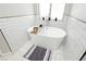 Bright bathroom showcases a freestanding tub, decorative tile flooring, and modern subway tile backsplash at 6100 Cocktail Dr, Las Vegas, NV 89130