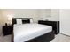 Modern bedroom features a dark-colored bed frame, side table, and dresser at 6100 Cocktail Dr, Las Vegas, NV 89130