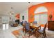 Open concept home showcases the dining area with a modern table and a view into the adjacent living spaces at 6100 Cocktail Dr, Las Vegas, NV 89130