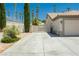 Expansive driveway and clean exterior offering ample parking and a welcoming entry to the property at 6100 Cocktail Dr, Las Vegas, NV 89130