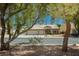 Charming single-story home with a well-manicured front yard, mature trees, and a three-car garage at 6100 Cocktail Dr, Las Vegas, NV 89130