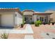 Single-story home featuring desert landscaping, a two-car garage, and a charming front porch at 6100 Cocktail Dr, Las Vegas, NV 89130