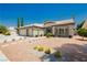 Attractive desert landscaping in front of a single-story house with a three-car garage at 6100 Cocktail Dr, Las Vegas, NV 89130