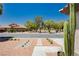 Attractive desert landscaping in the front yard with a view of a quiet street and well-maintained homes at 6100 Cocktail Dr, Las Vegas, NV 89130