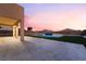 A covered backyard patio offers a beautiful view of the pool and landscaping at 6209 Exquisite Ave, Las Vegas, NV 89110