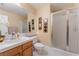 Bathroom featuring a single sink vanity, toilet, and a glass-enclosed shower at 6209 Exquisite Ave, Las Vegas, NV 89110