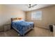 Inviting bedroom featuring a comfortable bed, ceiling fan, and bright natural light at 6209 Exquisite Ave, Las Vegas, NV 89110