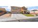 Inviting two-story home with a three-car garage, landscaping, and fenced yard at 6209 Exquisite Ave, Las Vegas, NV 89110