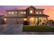 Lovely two-story home with a three-car garage and welcoming front porch at 6209 Exquisite Ave, Las Vegas, NV 89110