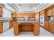 This bright kitchen features wood cabinets, granite counters, and stainless appliances at 6209 Exquisite Ave, Las Vegas, NV 89110