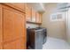 Well-equipped laundry room with modern washer and dryer and ample storage space at 6209 Exquisite Ave, Las Vegas, NV 89110