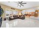Open-concept living room with ample natural light and direct access to kitchen and backyard pool at 6209 Exquisite Ave, Las Vegas, NV 89110