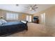 Bedroom featuring large bed, dresser, flatscreen TV, shuttered windows and plush carpet at 6209 Exquisite Ave, Las Vegas, NV 89110