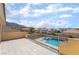 A spacious patio with a view of the pool, neighborhood and mountains beyond provides great outdoor living at 6209 Exquisite Ave, Las Vegas, NV 89110