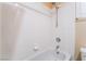 Bathroom shower with white tiles, shower head, and a small inset shelf at 6209 Exquisite Ave, Las Vegas, NV 89110