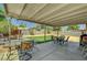 Covered patio with outdoor seating and a grill, perfect for enjoying the backyard and outdoor living at 671 Riata Way, Las Vegas, NV 89110