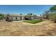 Large backyard featuring a well-maintained lawn and plenty of space for outdoor activities at 671 Riata Way, Las Vegas, NV 89110