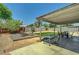 Spacious backyard with a covered patio, perfect for outdoor dining and entertaining guests at 671 Riata Way, Las Vegas, NV 89110