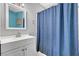 Bathroom featuring vanity with a mirror and blue shower curtain at 671 Riata Way, Las Vegas, NV 89110