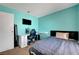 Bright bedroom features a work desk and a comfortable queen-sized bed at 671 Riata Way, Las Vegas, NV 89110