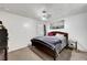 Bedroom with carpet features a ceiling fan and wall art at 671 Riata Way, Las Vegas, NV 89110