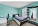 Comfortable bedroom with ample natural light, features a modern desk and wardrobe, ideal for relaxation at 671 Riata Way, Las Vegas, NV 89110