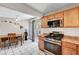 Kitchen area with stainless steel appliances, dining table, gas range, and sliding glass doors at 671 Riata Way, Las Vegas, NV 89110