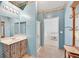 This bathroom has double mirrors, decorative sconces and an adjacent walk-in shower at 6868 Sky Pointe Dr # 1107, Las Vegas, NV 89131