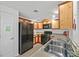 Well-lit kitchen showcasing stainless steel sink, wooden cabinetry, and modern appliances at 6868 Sky Pointe Dr # 1107, Las Vegas, NV 89131