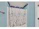 Close-up of a bathtub and shower combination with a patterned shower curtain at 6868 Sky Pointe Dr # 1107, Las Vegas, NV 89131