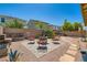 Backyard featuring a gravel area with fire pit seating, providing a cozy outdoor retreat at 7224 Piute Mesa St, North Las Vegas, NV 89084