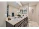 Bathroom featuring a double sink vanity, a large mirror, and neutral paint at 7224 Piute Mesa St, North Las Vegas, NV 89084